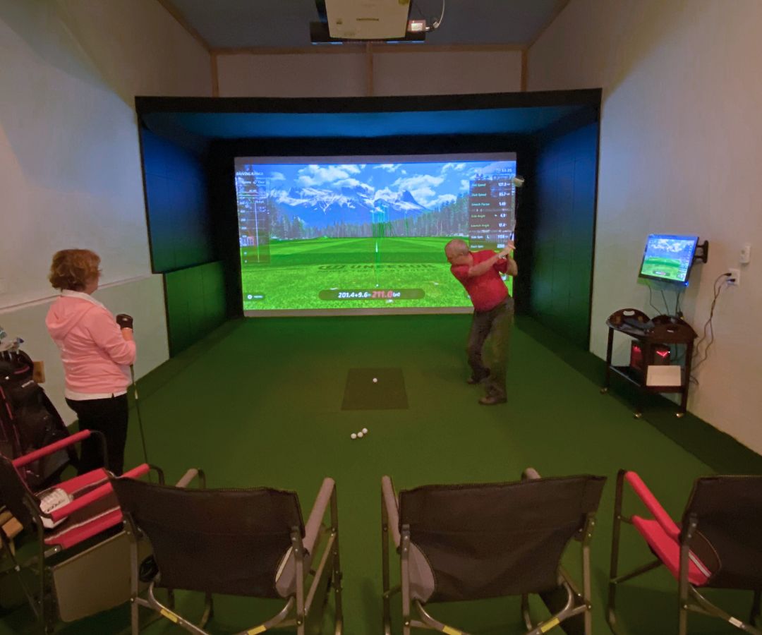Family playing with a golf simulator