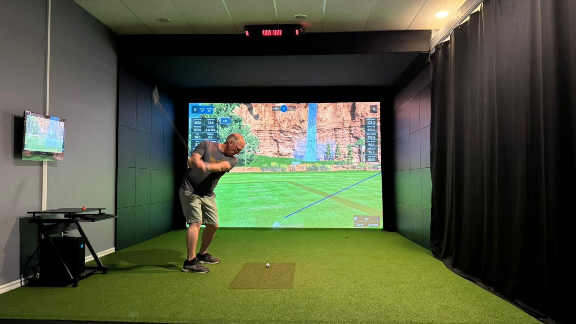 Custom Golf Simulator Install, completed build with golfer swinging.