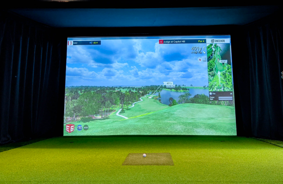 Residential golf simulator with strike mat and curtains 